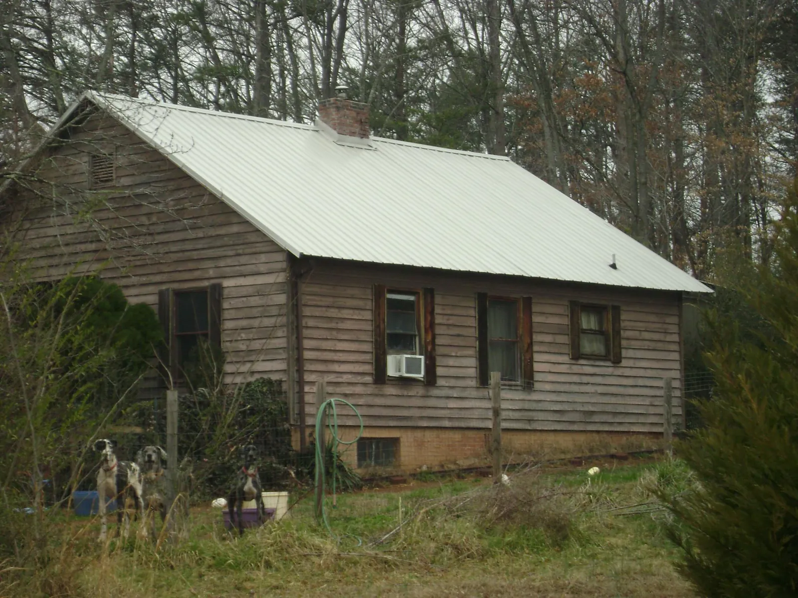 White metal roof on an old wood sided farmhouse, from a Metal Roof Installation job in Cordele